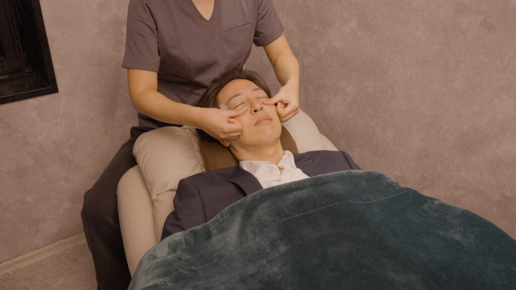 目のリラクゼーションサロン、ANDBLINQで施術を受ける男性
