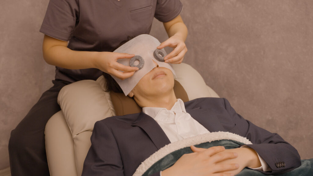 目のリラクゼーションサロン、ANDBLINQで施術を受ける男性