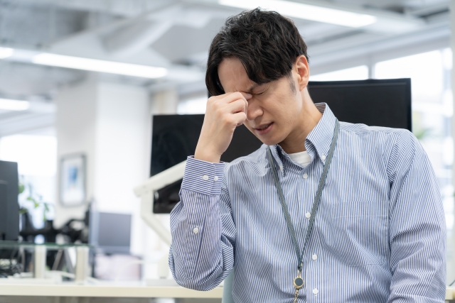 ストレスで目がピクピクする男性
